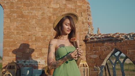 woman with flower in ruins