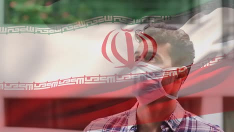 animación de la bandera de irán ondeando sobre un hombre latino con máscara facial en la calle de la ciudad