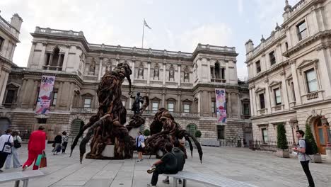 people interacting with a large outdoor sculpture