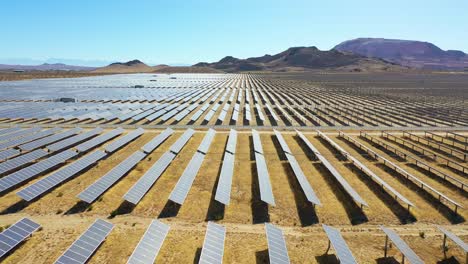 forward drone aerial of vast solar array in mojave desert california suggests clean renewable green energy resources