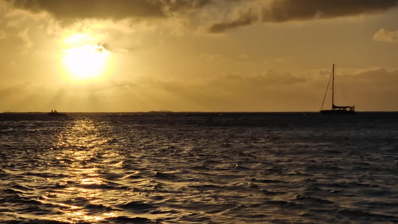 Idyllic Sunset on French Polynesia, Sailboat adn Boat on Sea and Sunlight Reflections