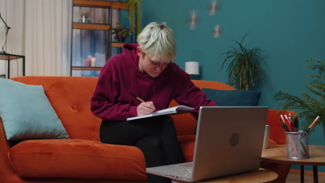 young woman teacher study at home on laptop computer making conference video call talking to webcam