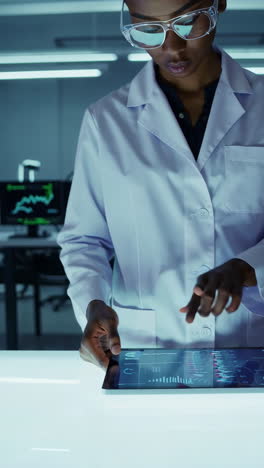 Scientist Analyzing Data on Digital Tablets in a Futuristic Lab
