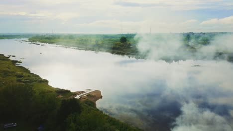 a scenic aerial view of atmospheric climate, mirrored reflection of clouds on daugava river, daugavpils city, latvia