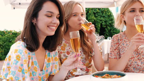 three women celebrating with champagne