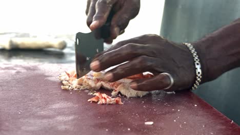 Close-Up-of-Black-Male-Hands-Shredding-Lobster-on-Table,-Full-Frame