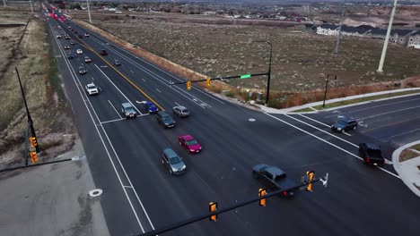 Aerial-View-of-Vehicles-Trafiic-at-Light-over-S-Redwood-road-Street-in-Bluffdale-Utah,-Orbit-Movement