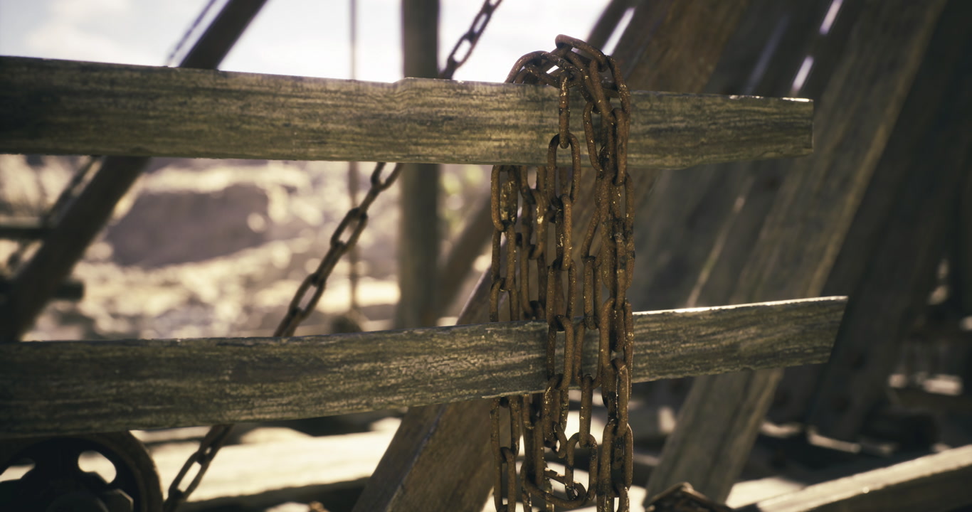 Rusty chains hang on weathered wooden beams in an abandoned structure
