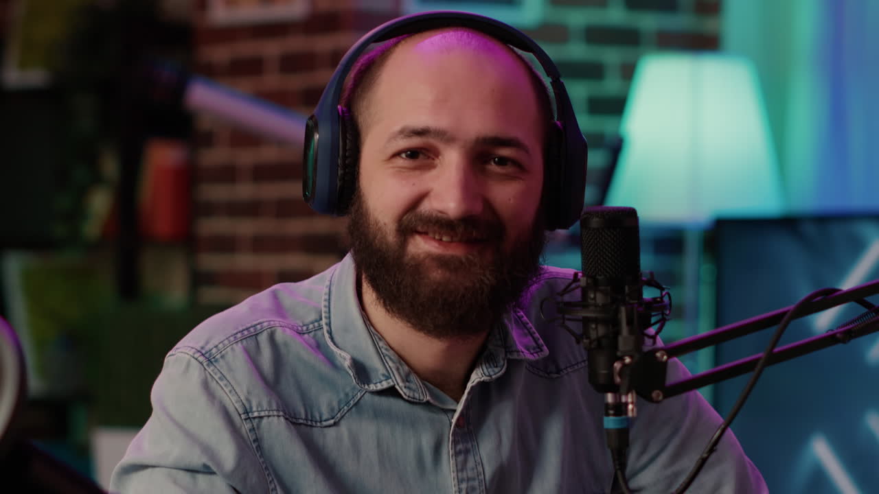 Closeup portrait of man recording online podcast with professional microphone smiling at camera
