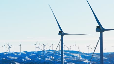 Bessaker,-Trondelag-County,-Norway---Wind-Turbines-Installed-on-a-Snow-blanketed-Mountain---Medium-Shot