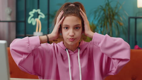 portrait of sad scared caucasian preteen school girl holding her head failed exam mistake problem