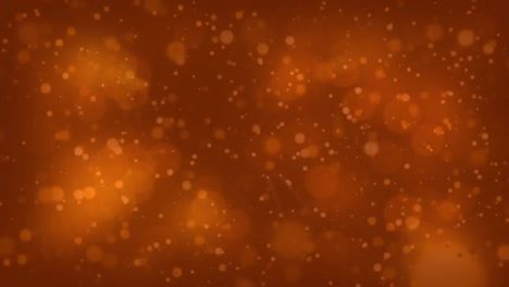 animation of glowing light spots moving over orange background