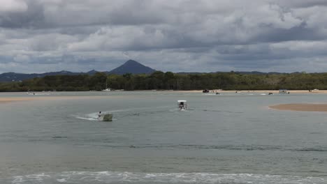 multiple speedboats race across a tranquil lake