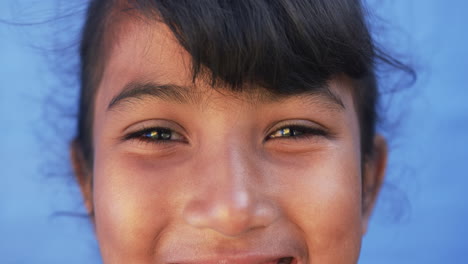 In-a-school-setting,-a-close-up-captures-a-young-biracial-student-smiling