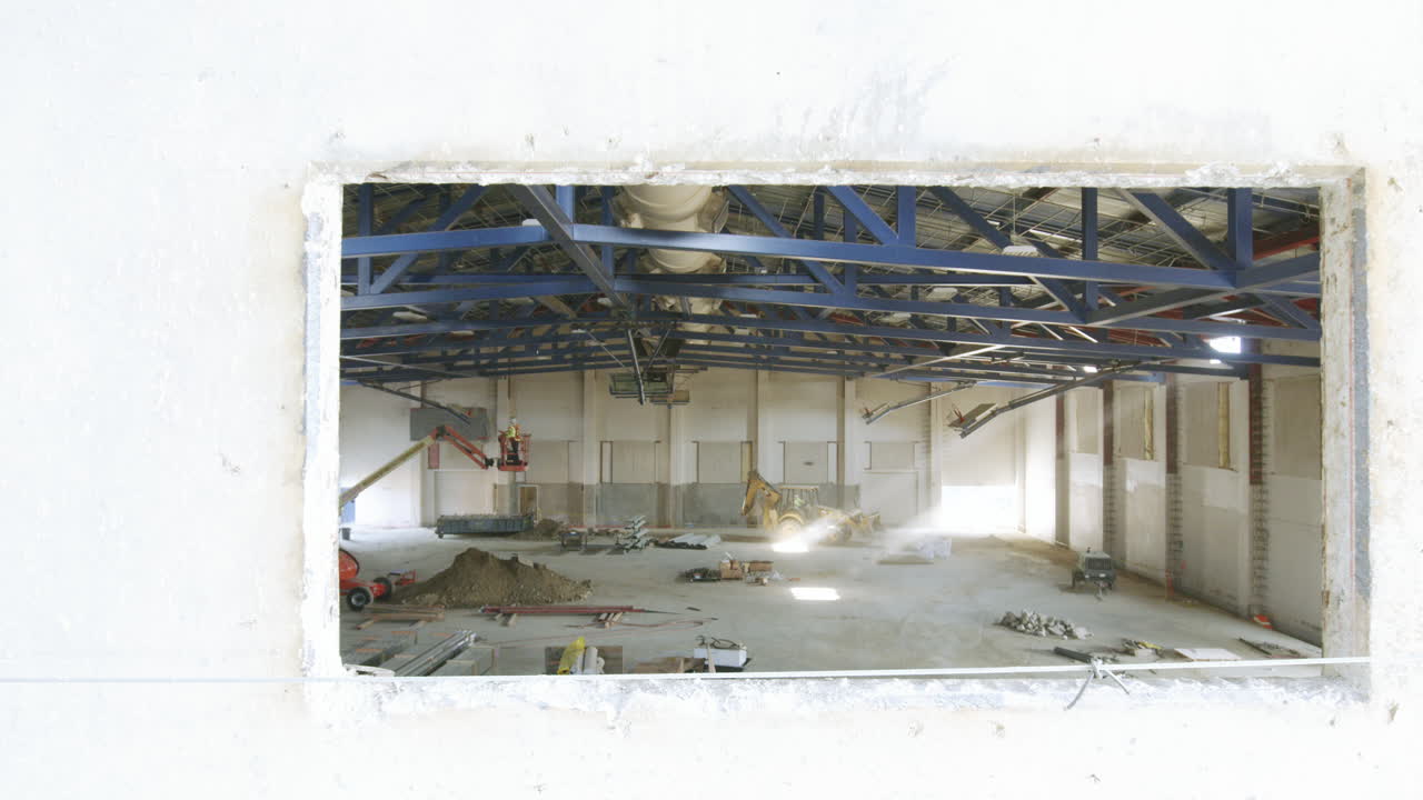 Large Indoor Building Under Construction with Equipment