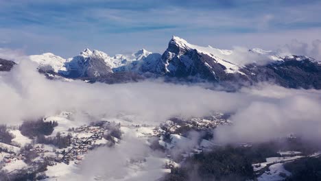 An-above-the-clouds-aerial-hyperlapse-of-the-snow-covered-valley-of-Giffre-in-Haute-Savoie-with-the-Criou-peak-in-the-background,-French-Alps