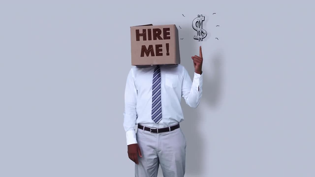 Businessman wearing hire me box and pointing on dollar sign