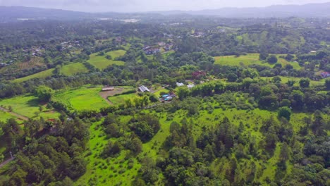 Aerial-flyover-green-landscape-of-Dominican-Republic-during-sunny-day-with-fog