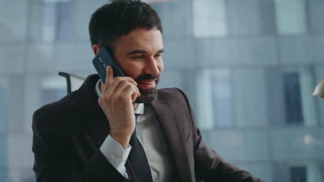 successful investor speaking smartphone sitting office closeup. businessman call