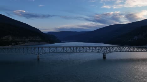 Lake-Koocanusa-With-Bridge-At-Dusk,-Montana,-USA---aerial-drone-shot