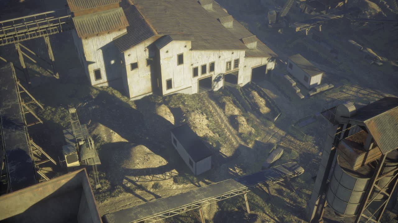 Old industrial buildings against a dusty landscape in the late afternoon light