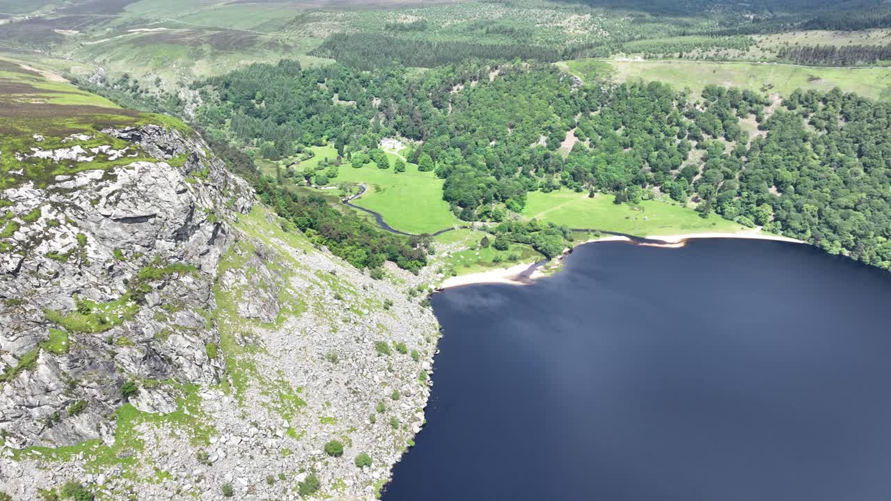 Ireland Epic Locations Wicklow drone flying past rock face at Lough tay sonic destination in the high Mountains Wicklow