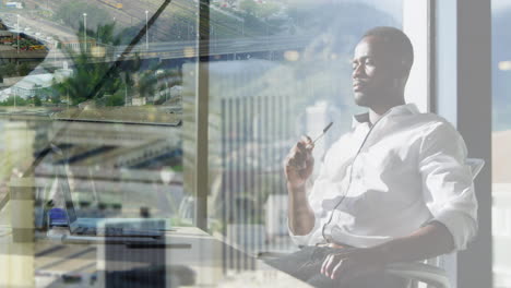 animation of african american businessman in office over cityscape