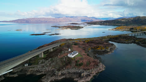 drone descends and pulls away from coastal island between skye bridge in scotland