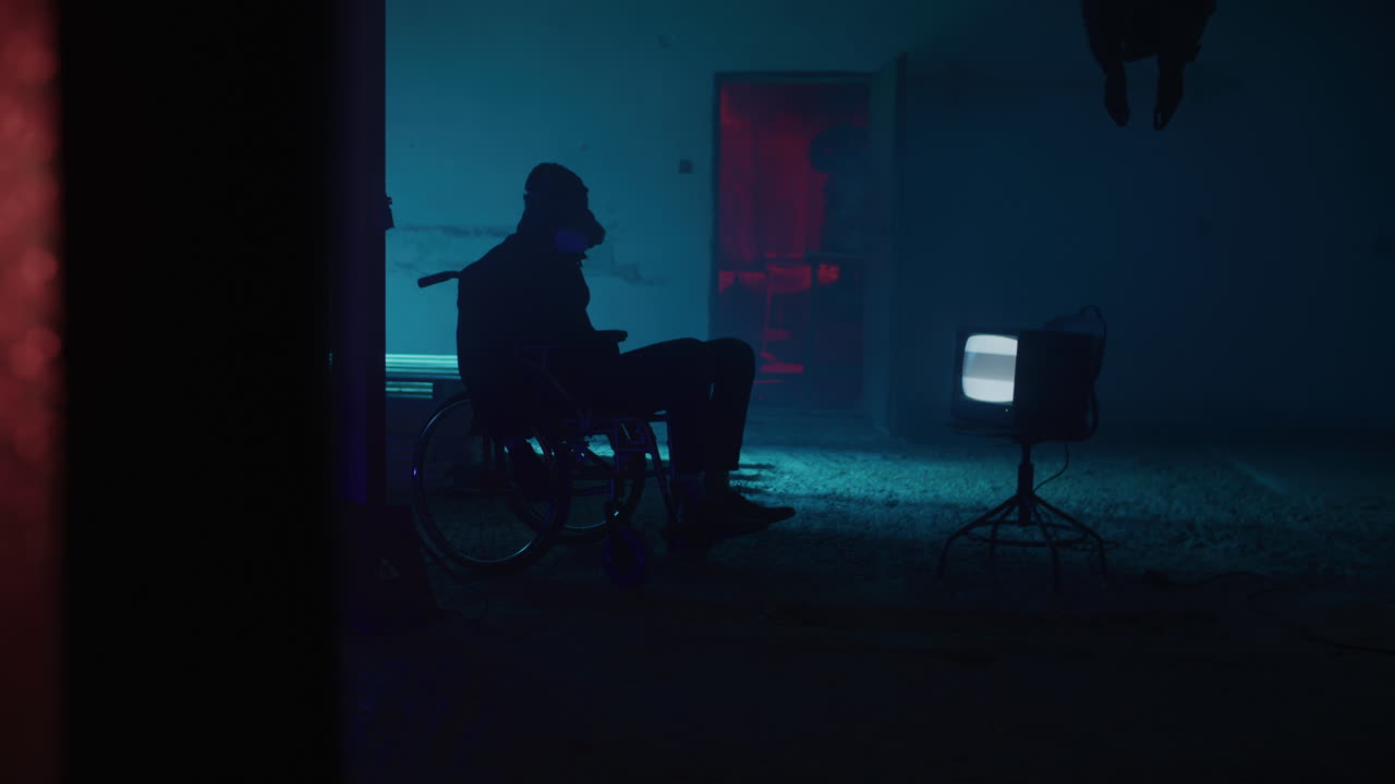 A Person in a Wheelchair in a Neon-Lit Abandoned Room