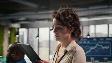 vertical video female office administrator using digital tools for kpi analytics