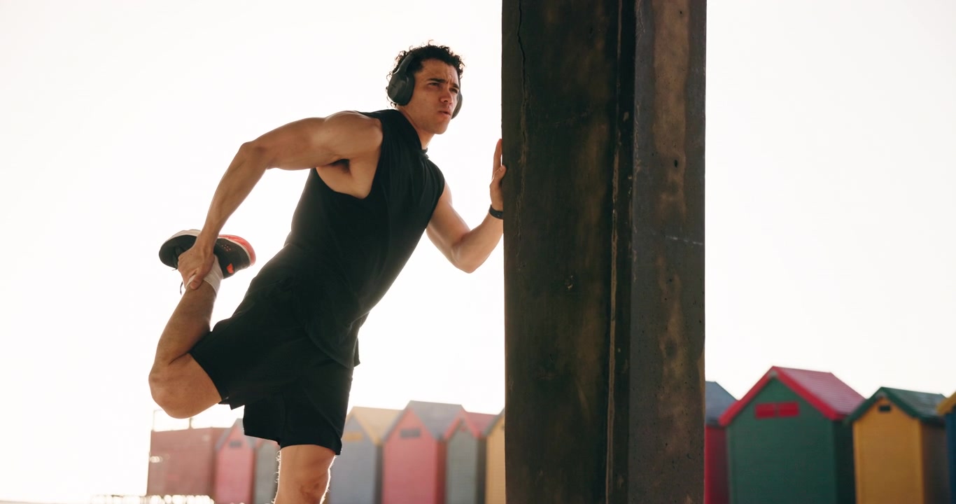Athletic Man Stretching Legs Outdoors at Sunset