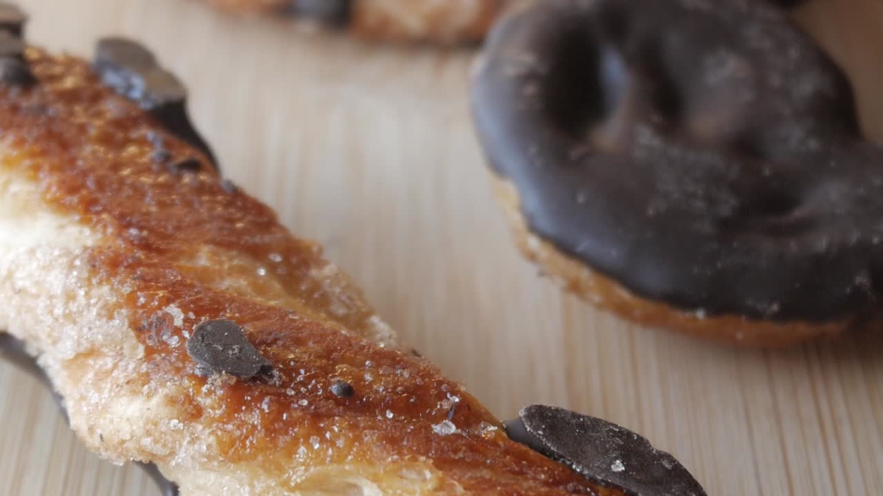 Golden, crispy palmeras chocolate pastry with sugar and chocolate topping