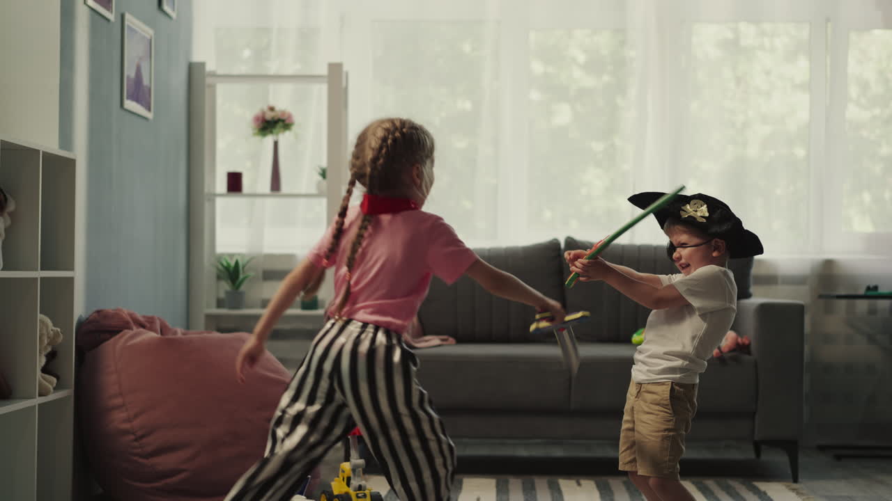 Couple of kids siblings has fun playing with toy swords