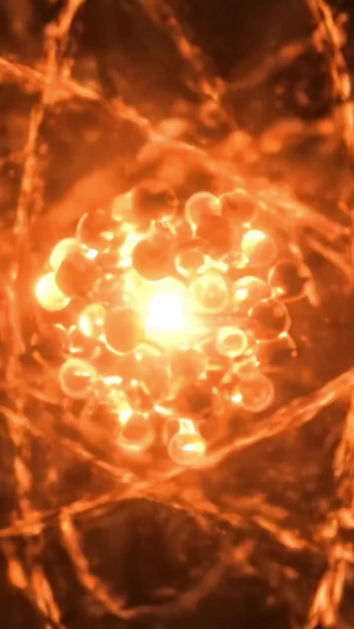 A Stunning Visualization of Atomic Structure: Exploring the Dynamic Energy of Electrons Orbiting a Vibrant Nucleus in Hypnotic Orange and Gold Tones