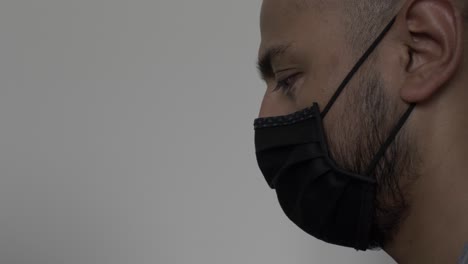 UK-Asian-Male-Wearing-Cotton-Face-Mask-Whilst-Gazing-Downwards