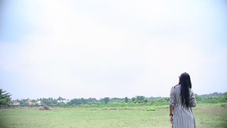 girl standing in meadow grassland looks at blank sky awestruck, sky can be replaced into sci fi