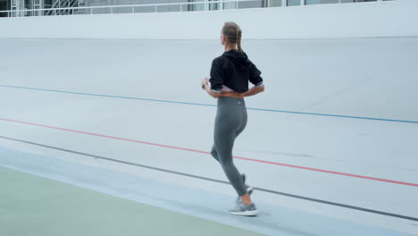 woman with artificial limb jogging on track