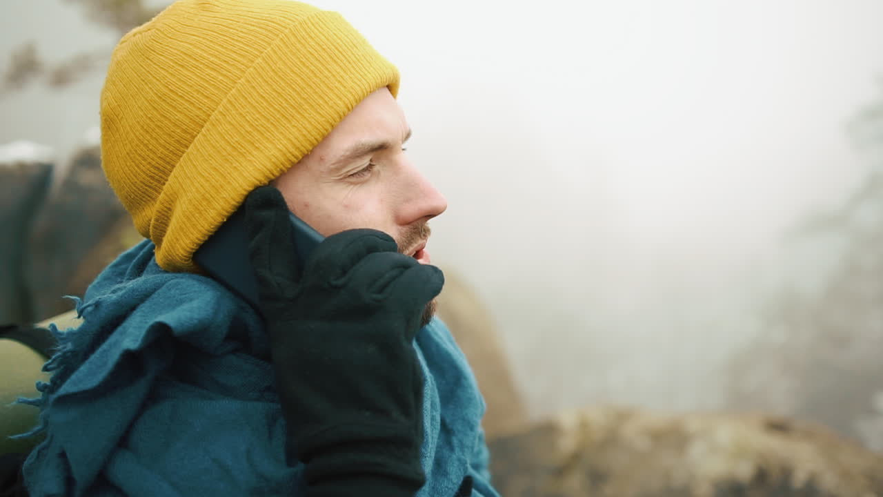 Man talking on phone in the mountains