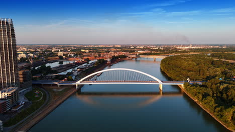 sunset view of the danube in bratislava, slovakia. drone descending above the waterscape with the view on the appolo bridge