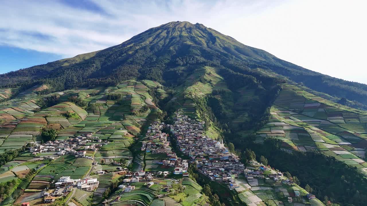 Aerial view of Mountain and rural landscape featuring lush terraces and a traditional village on the slope. Mount Sumbing, Indonesia