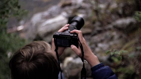 man handling camera in nature environment, slow motion, norway, europe