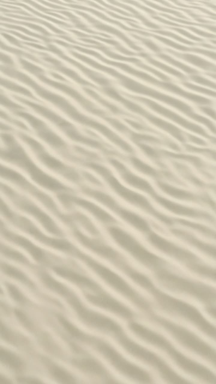 Aerial view of rippled sand texture, resembling gentle waves