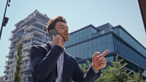 furious manager arguing smartphone walking business area close up. man yelling