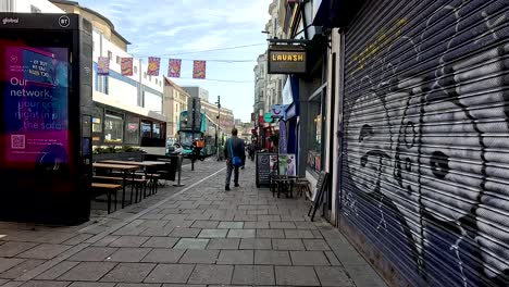 people and buses in lively shopping area