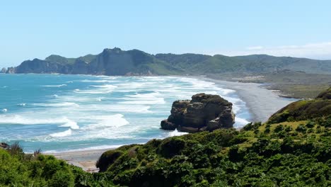 waves and a beach at the tepuhueico park coast zone, sunny day in chiloé, chile