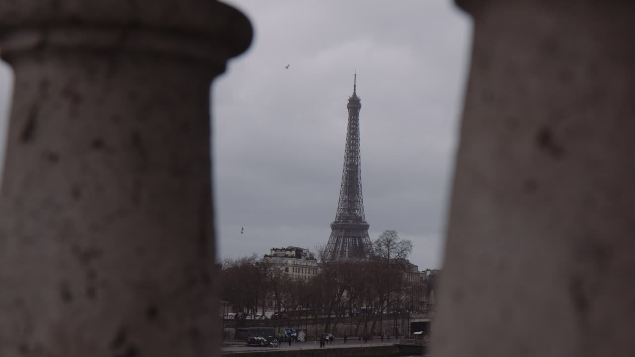 Eiffel Tower Between The Stone Balustrade Of Bridge In Paris, France