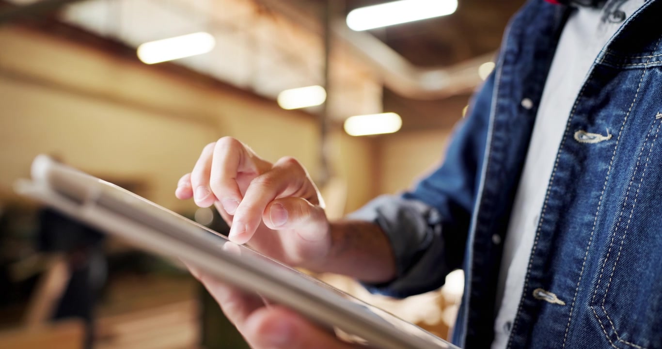 Person Using Digital Tablet in Industrial Workshop