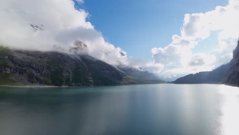 Aerial-flight-over-a-beautiful-big-Oeschinen-lake-on-a-mountain-in-Switzerland