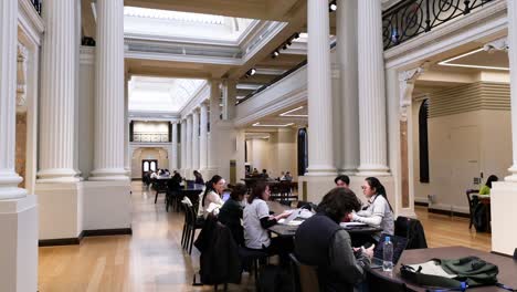 people studying in a grand library hall