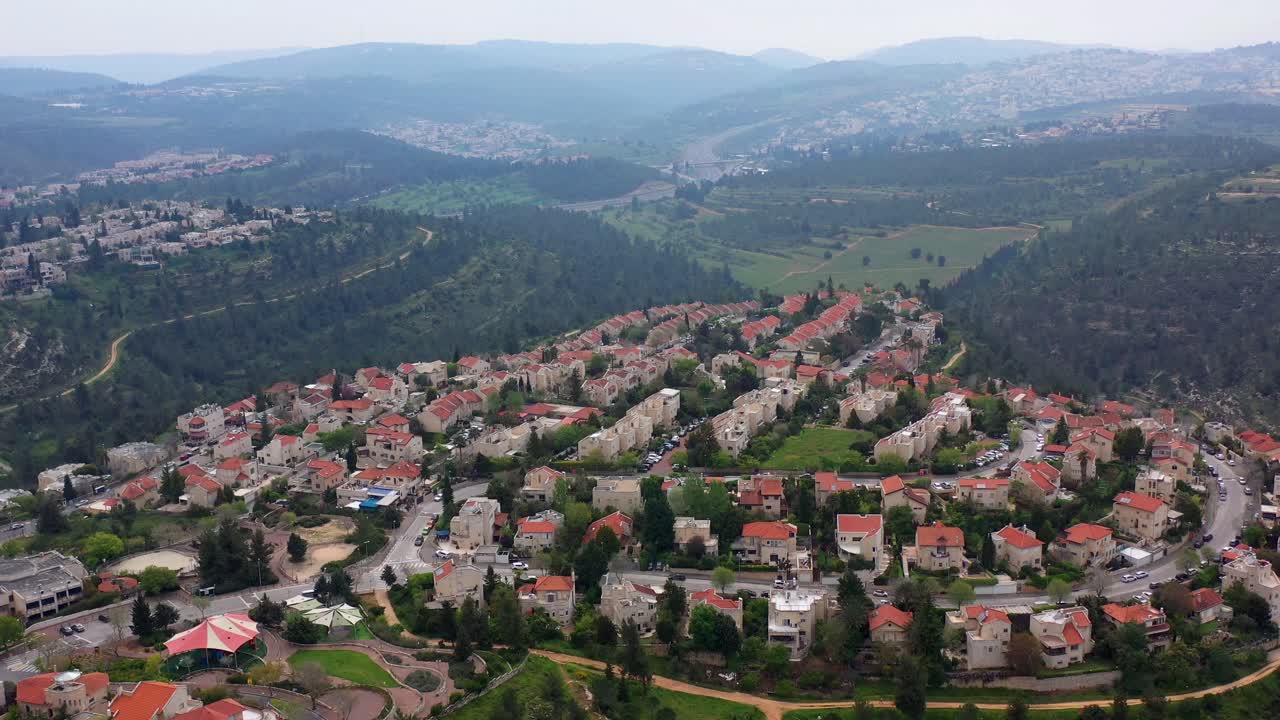 Aerial View of a Residential Neighborhood in a Hilly Forested Landscape